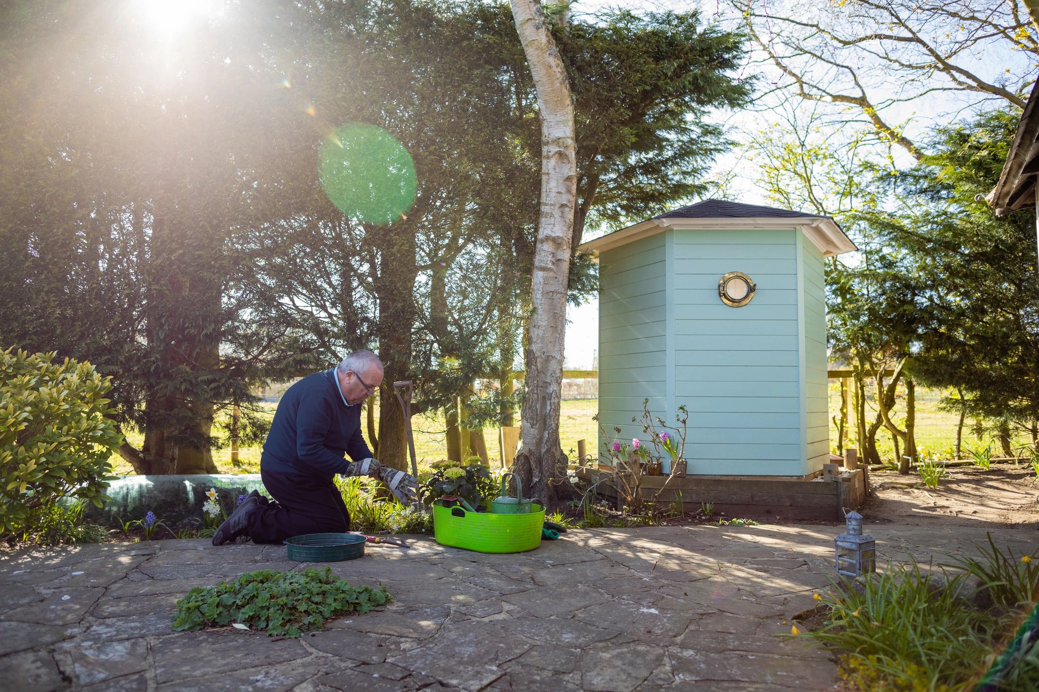 Homeowner working in a garden during seasonal cleanup