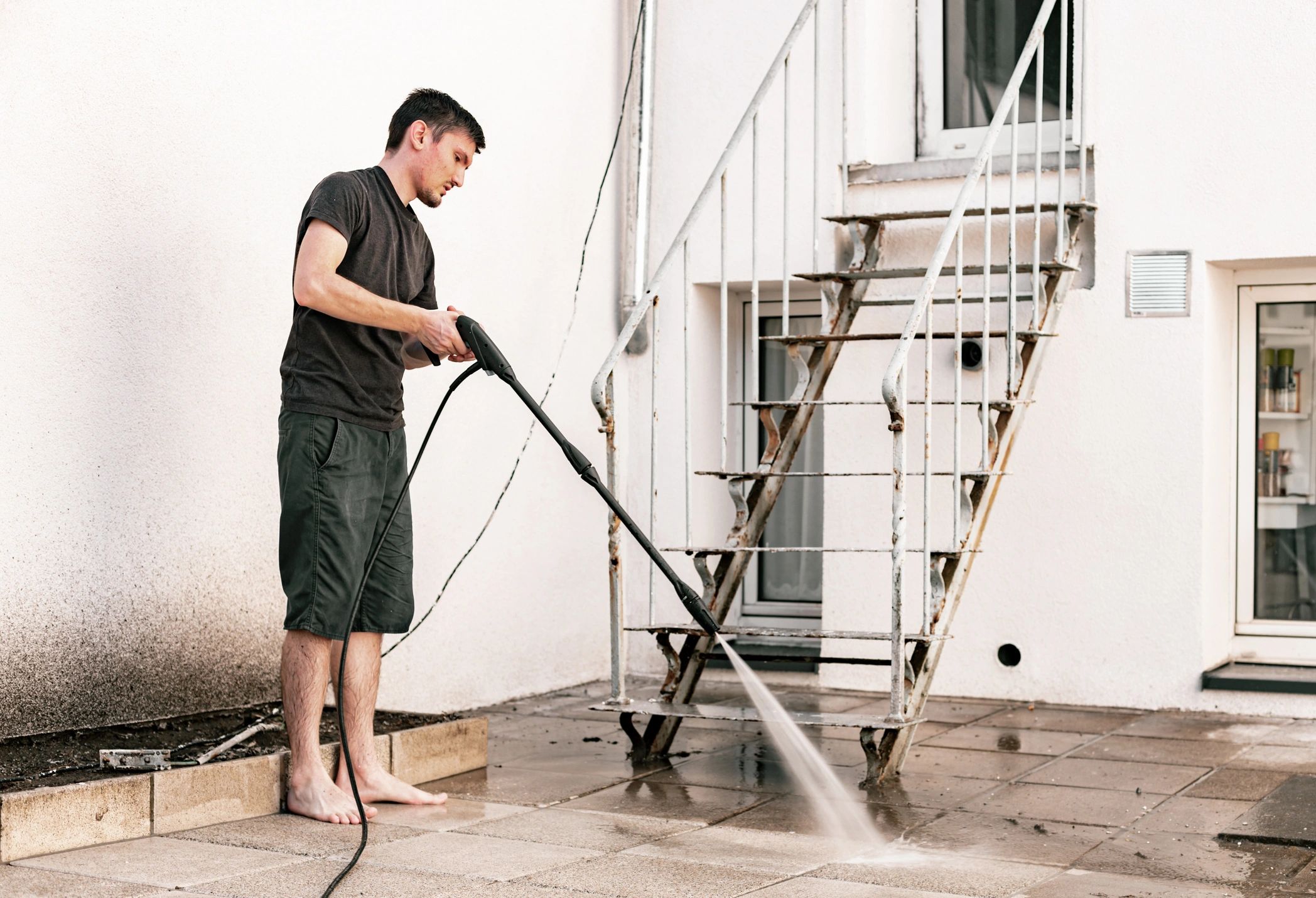 Pressure washing outdoor surfaces